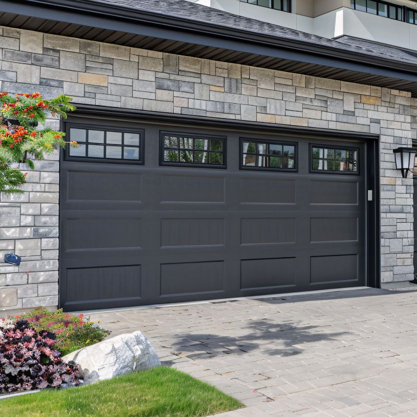 A home with a newly replaced dark garage door
